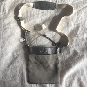Coach cross body purse in silver logo print. Like new (one scratch on back)